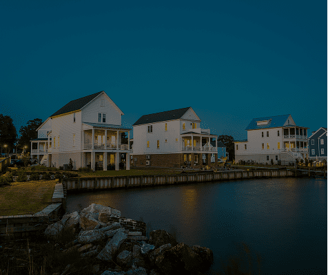 Waterfront homes under a dusky sky